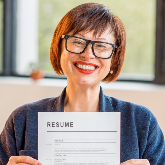 Smiling Woman Holding Up a Resume